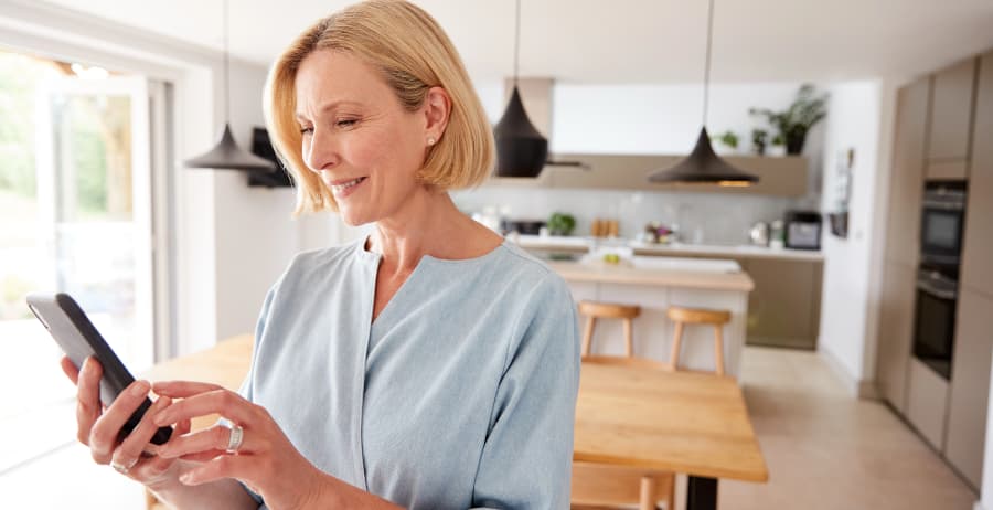 Resident using a smartphone in a modern home